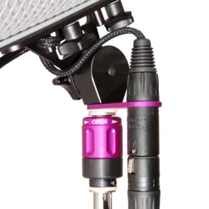 Ambient QAT-ECO XLR Holder for Boom Poles: The QAT-ECO on a boom pole tip, holding an XLR connector under a windshield.