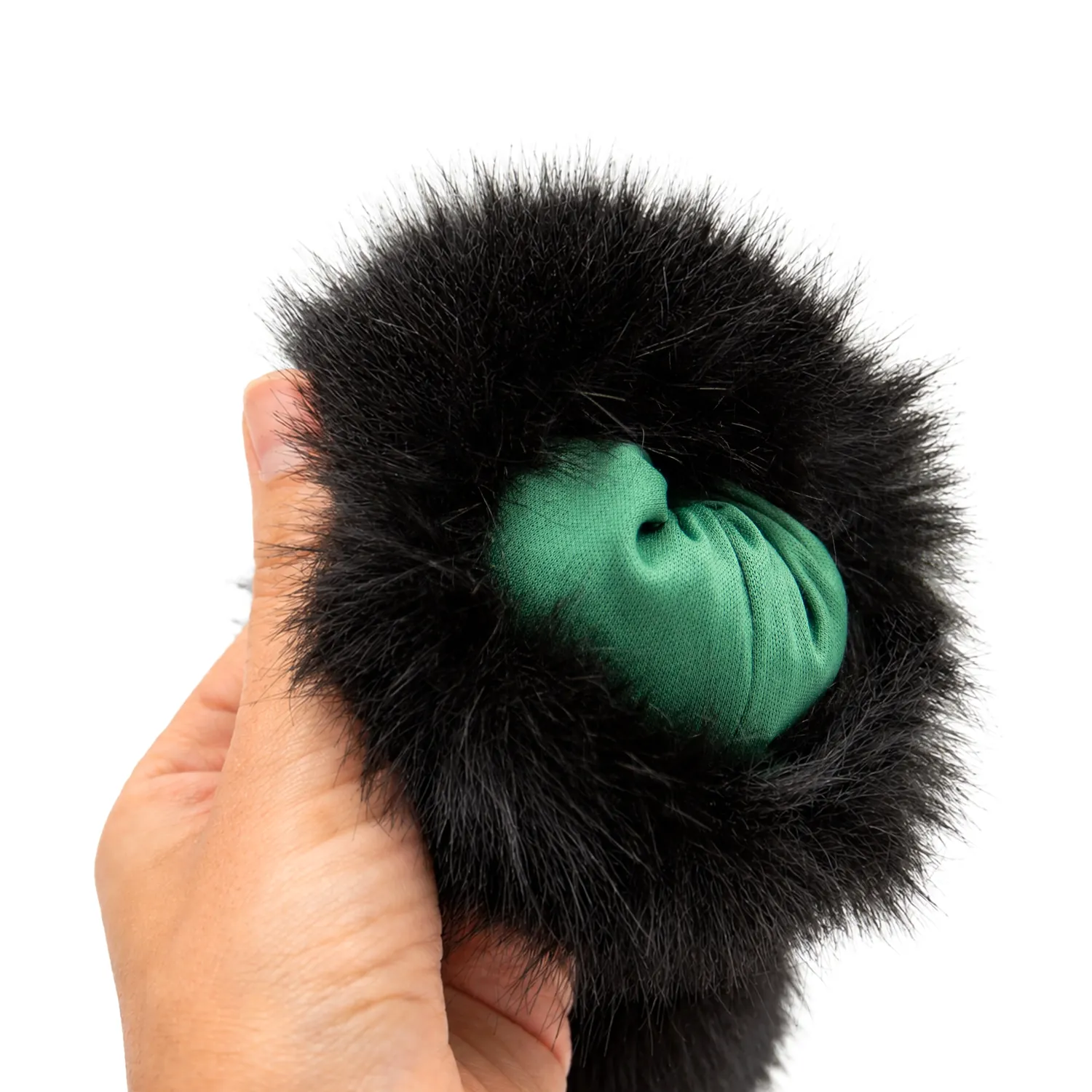 Bubblebee Industries The Foam Wind Cover Kit for Shotgun Mics: a hand holding the black fur cover open to show the green fabric inside.