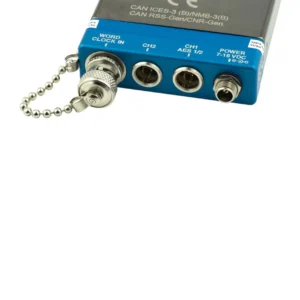 Lectrosonics SRAES3 Audio Output Adapter for SR Series Receivers: The labeled jack panel with its word clock cap on a chain.
