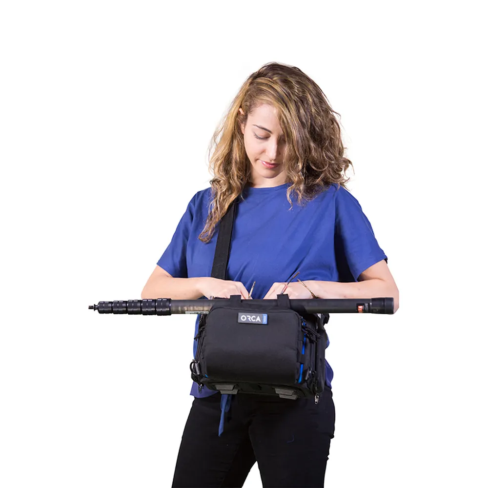 ORCA OR-28 Small Audio Mixer Bag for Zoom F8 and MixPre-6: worn with a boom pole across the bag.