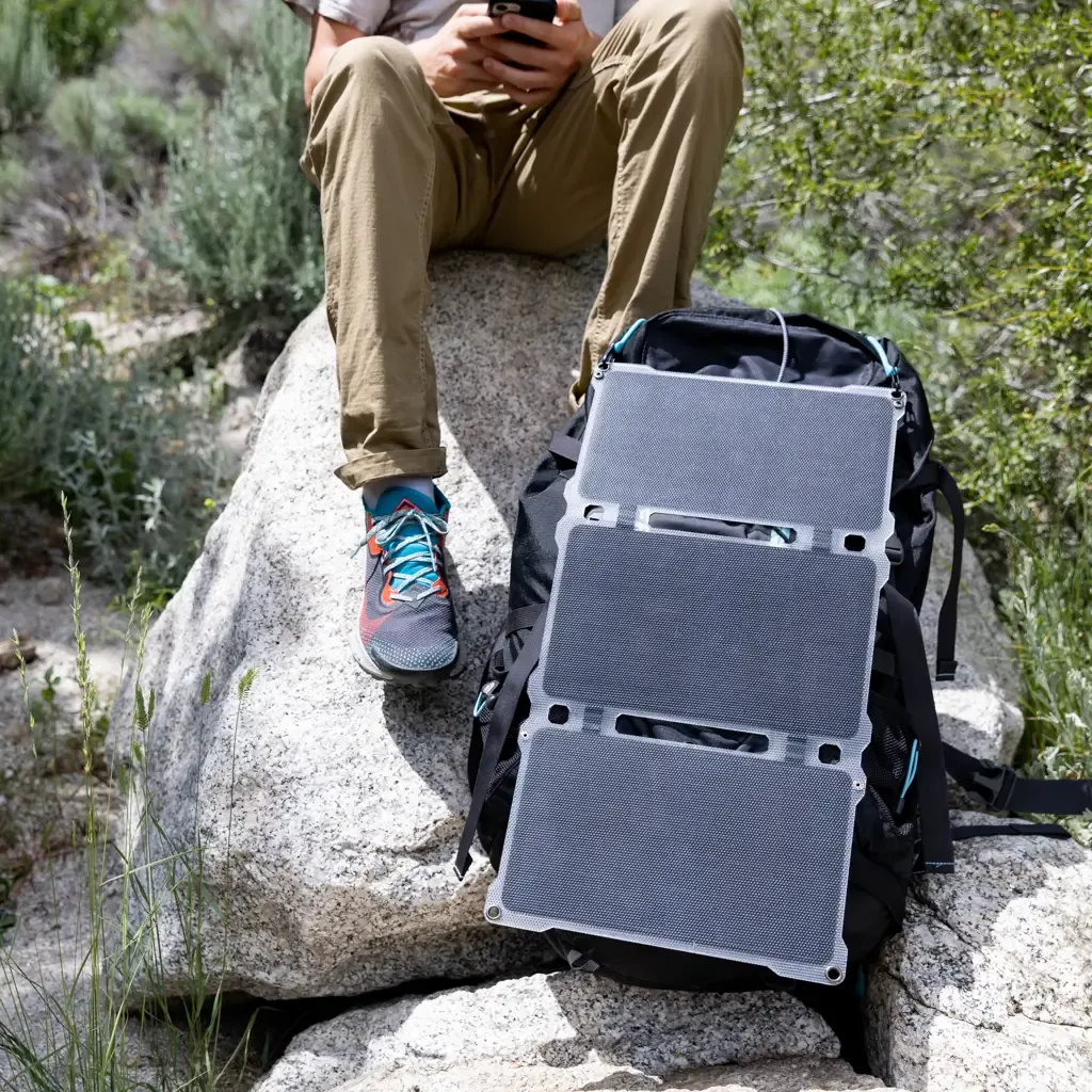 Paleblue AA & AAA Solar Power Kit with Approach 2 Solar Charger: the Approach 2 Solar Charger strapped to a backpack on a rock in the sun.