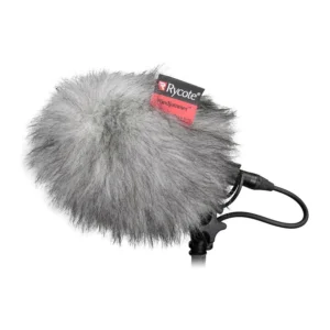 Rycote BBG Windjammer Fur Cover for BBG Windshield fitted over a BBG windshield on a stand, with the Rycote label on the fur and the microphone cable leaving below.