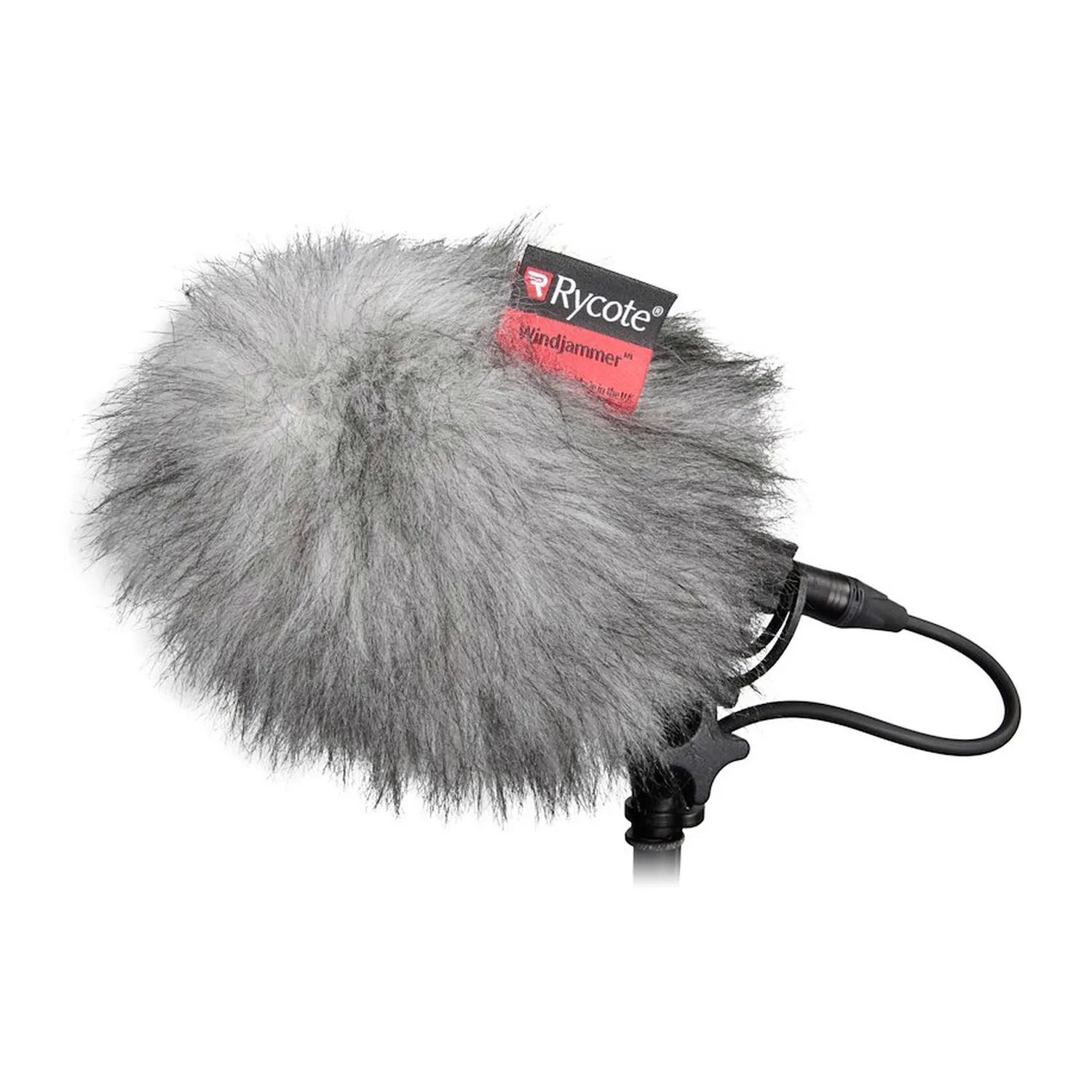Rycote BBG Windjammer Fur Cover for BBG Windshield fitted over a BBG windshield on a stand, with the Rycote label on the fur and the microphone cable leaving below.