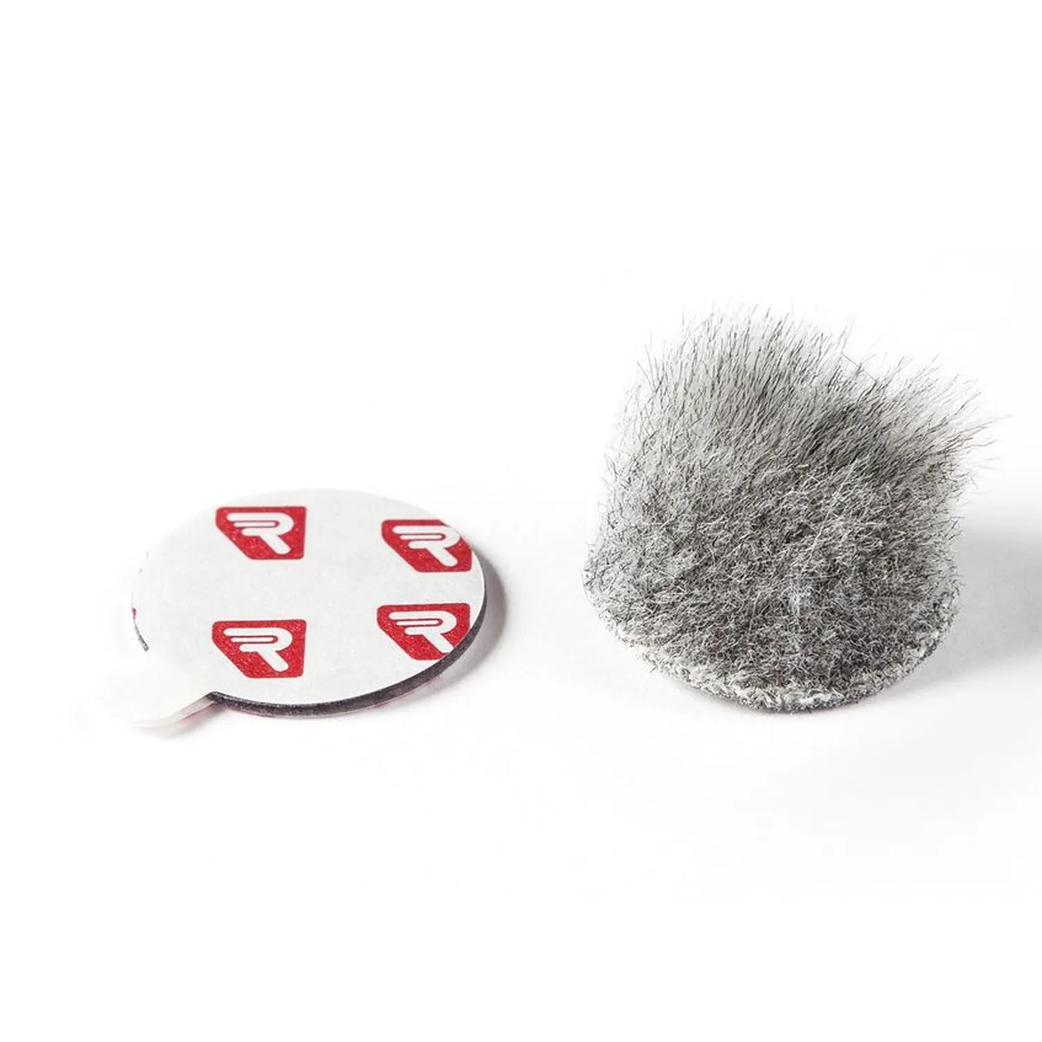 Rycote Overcovers Advanced - Gray: A gray Overcovers Advanced fur disc beside a sheet of round Stickies.
