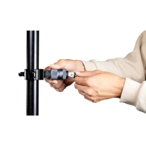 Rycote PCS-Utility Half Coupler Kit Small, hands fitting the PCS-Utility to a clamp on a pole.
