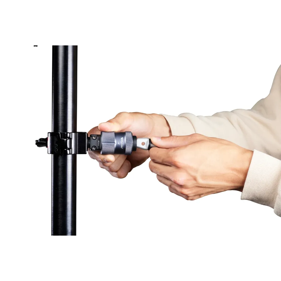 Rycote PCS-Utility Half Coupler Kit Large, hands fitting a PCS tip into the PCS-Utility socket on a half coupler clamped to a pole.