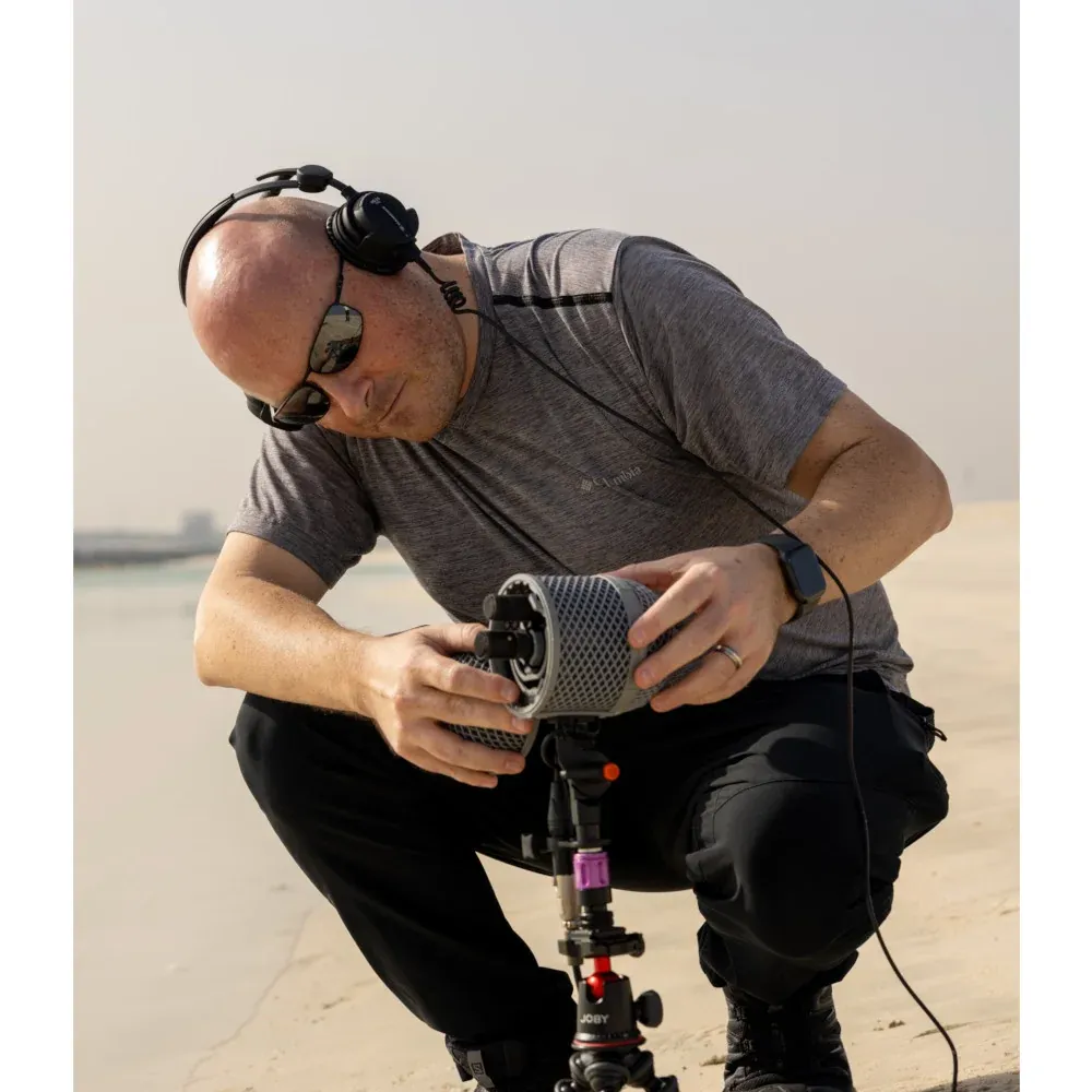 Sennheiser MKH 8030 Figure-8 Condenser Microphone: A recordist setting up an MKH 8030 stereo rig outdoors.