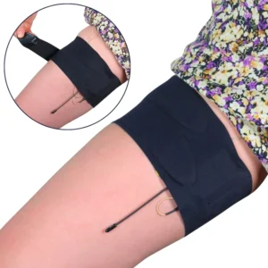 URSA Thigh Strap - Black with the split end, worn high on the thigh under a floral skirt with a lav cable leading out, and an inset of one end being fastened.