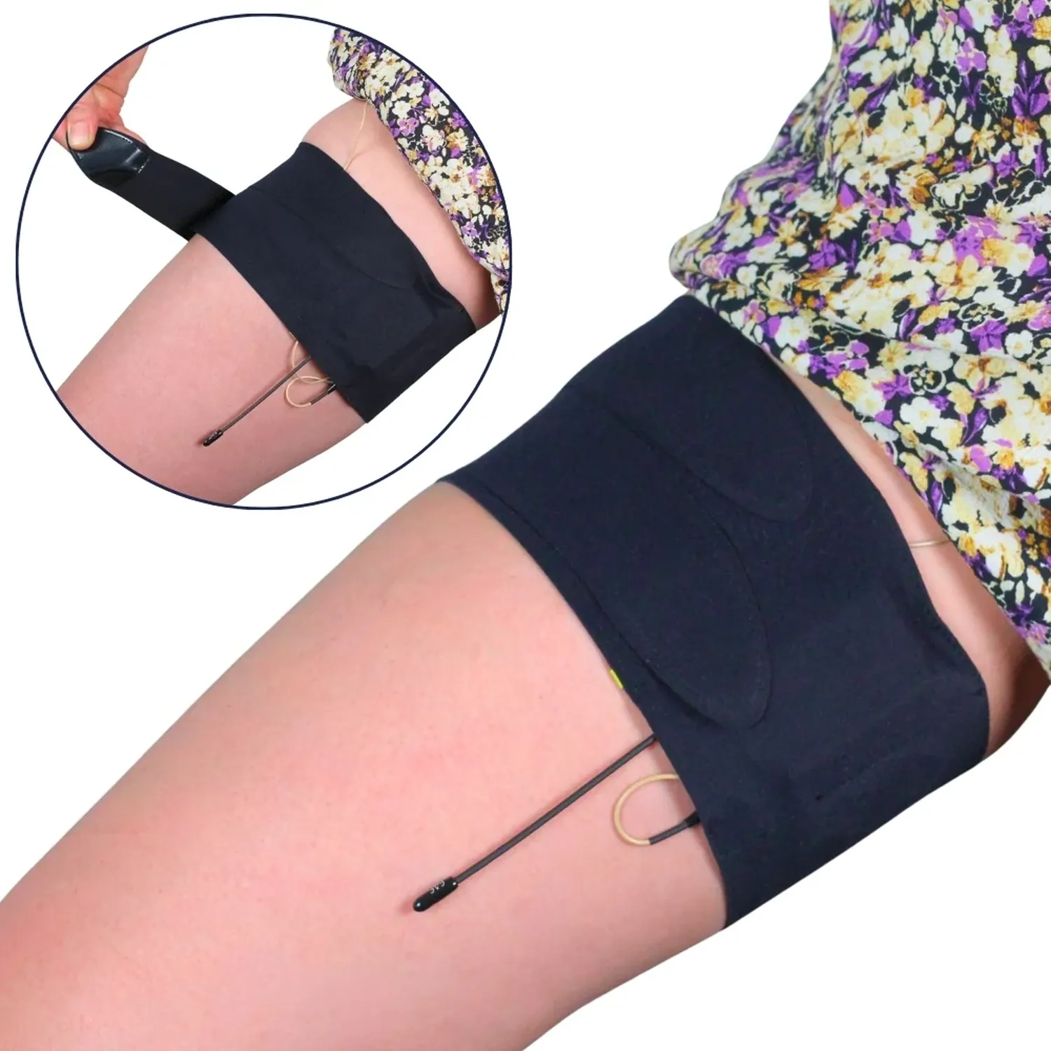 URSA Thigh Strap - Black with the split end, worn high on the thigh under a floral skirt with a lav cable leading out, and an inset of one end being fastened.