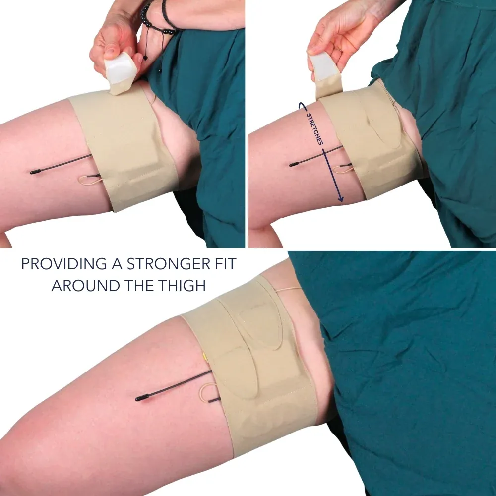 URSA Thigh Strap in beige on the thigh, its two split ends fastened one after the other for a closer fit, with a lav cable running from the pouch.