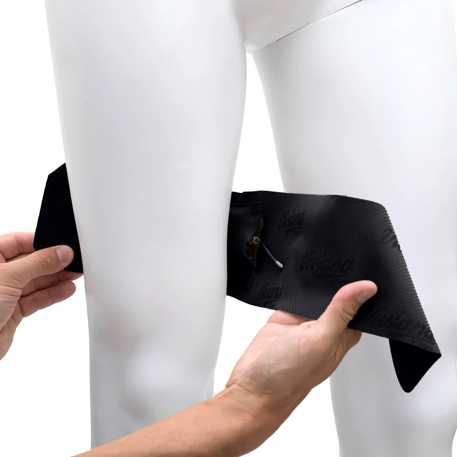 Viviana Straps Extreme Thigh (Horizontal Pouch) in black, held open against a mannequin's thigh to show the transmitter in its horizontal pouch.