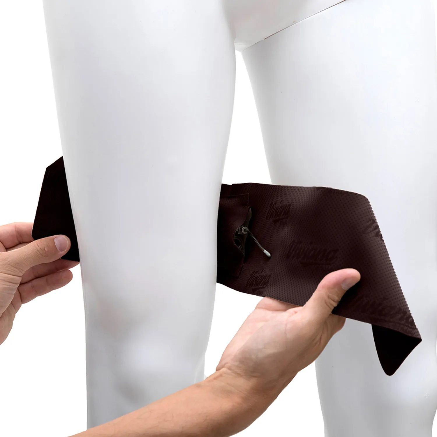 Viviana Straps Extreme Thigh (Horizontal Pouch) in brown, held open against a mannequin's thigh to show the transmitter in its horizontal pouch.